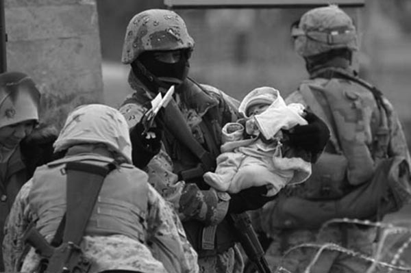 Iraqi soldiers help carry a baby through a checkpoint during the January 2005 elections. 
